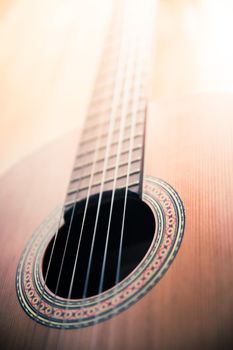 Cutout of a classical guitar corpus and strings, closeup