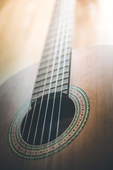 Cutout of a classical guitar corpus and strings, closeup