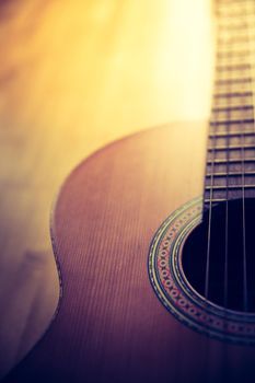 Cutout of a classical guitar corpus and strings, closeup