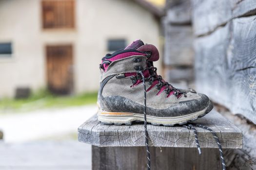 Close up picture of hiking boots on a rustic wooden veranda of an alpine hut