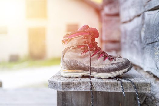 Close up picture of hiking boots on a rustic wooden veranda of an alpine hut