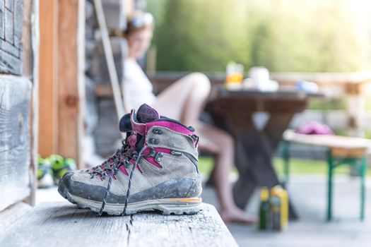Close up picture of hiking boots on a rustic wooden veranda of an alpine hut