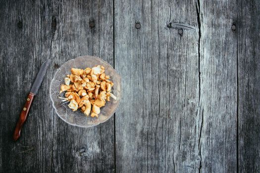 Preparing chanterelle mushrooms on an old rustic wooden table