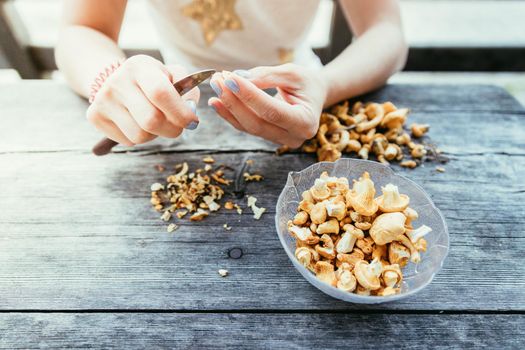 Preparing chanterelle mushrooms on an old rustic wooden table