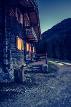 Rustic wooden farm hut in the night. European alps, Austria