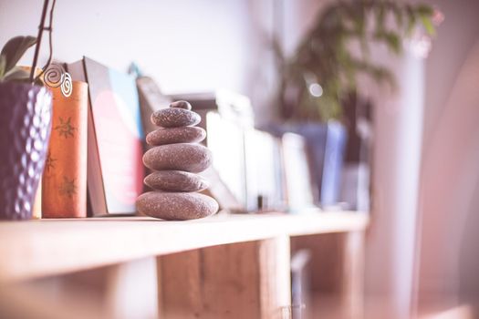 Feng Shui: Stone cairn in the foreground, blurry living room in the background. Balance and relaxation.