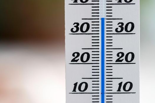 Thermometer close up picture in summer time, blurry background