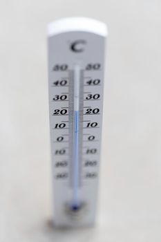 Thermometer close up picture in summer time, concrete floor