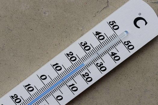 Thermometer close up picture in summer time, concrete floor