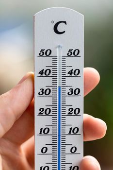 Thermometer close up picture in summer time, blurry background