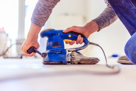 Close up of a sander power tool for DIY on wooden parquet floor