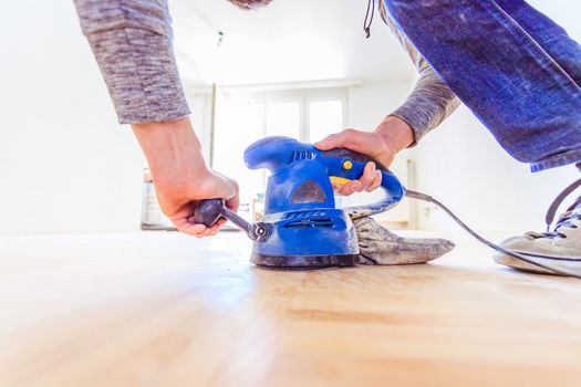 Close up of a sander power tool for DIY on wooden parquet floor