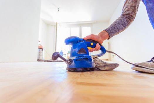 Close up of a sander power tool for DIY on wooden parquet floor