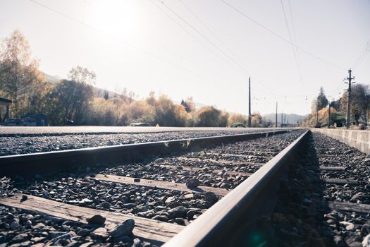 Landscape of an old abandoned railway in fall. Warm light, sustainable traveling