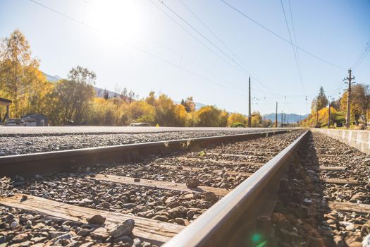 Landscape of an old abandoned railway in fall. Warm light, sustainable traveling
