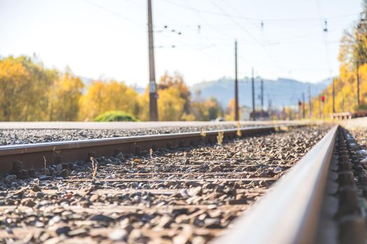 Landscape of an old abandoned railway in fall. Warm light, sustainable traveling