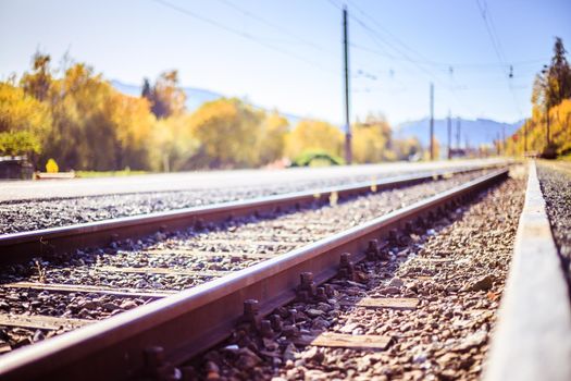 Landscape of an old abandoned railway in fall. Warm light, sustainable traveling