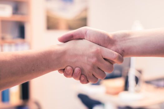 Man and woman are shaking hands, close up image, concept for human relationships