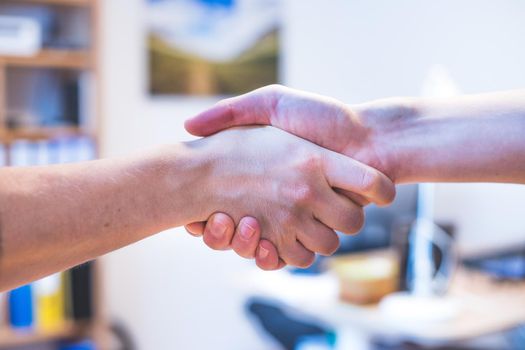 Man and woman are shaking hands, close up image, concept for human relationships