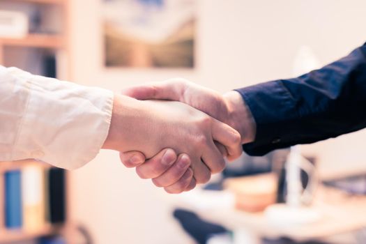 Man and woman are shaking hands, close up image, concept for human relationships