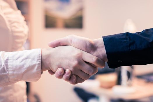 Man and woman are shaking hands, close up image, concept for human relationships
