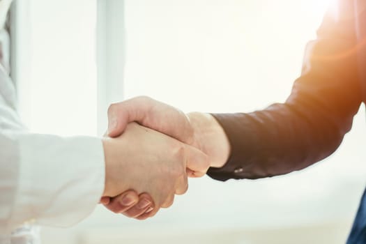 Man and woman are shaking hands, close up image, concept for human relationships