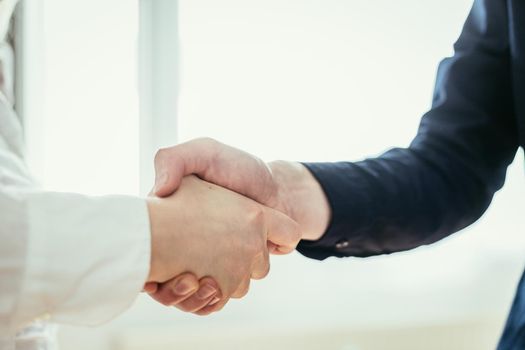 Man and woman are shaking hands, close up image, concept for human relationships