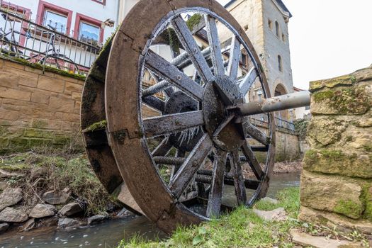 Water wheel in winter with icicles in Meisenheim, Germany