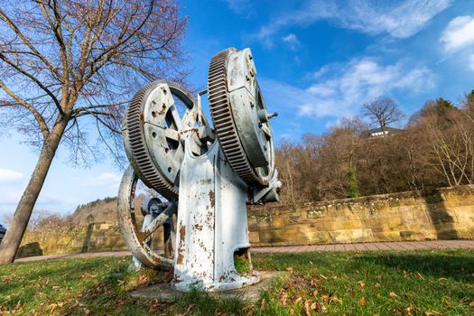 Historic water pump with gears on the Glan promenade in Meisenheim, Germany