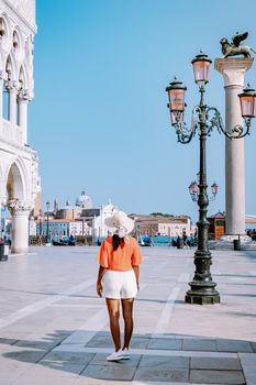 woman on a city trip to Venice Italy, colorful streets with canals Venice. Europe