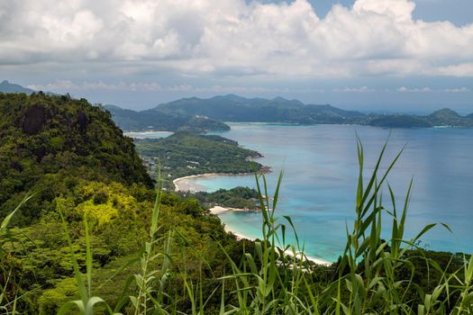 Panoramic view at the landscape on Seychelles island Mahé with clear blue water and green mountains