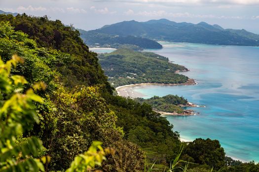 Panoramic view at the landscape on Seychelles island Mahé with clear blue water and green mountains