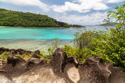 Panoramic view at the landscape on Seychelles island Mahé with turguoise water, mountains  and granite rocks 