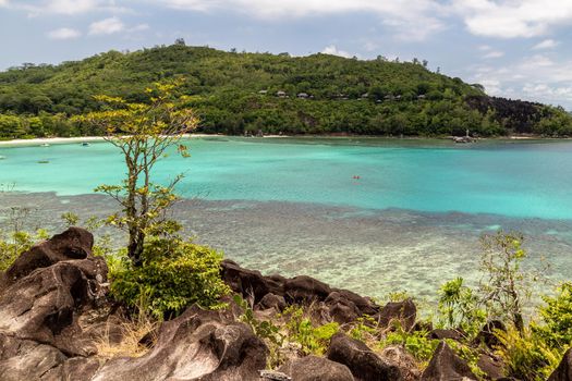 Panoramic view at the landscape on Seychelles island Mahé with turguoise water, mountains  and granite rocks 