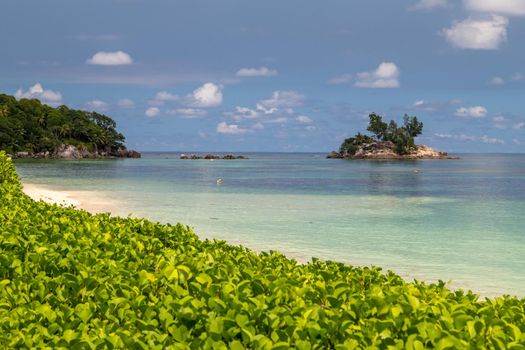 Paradise beach anse royale on Seychelles island Mahé with turguoise water, palms, white sand and granite rocks