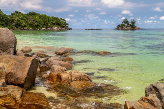 Paradise beach anse royale on Seychelles island Mahé with turguoise water, palms, white sand and granite rocks