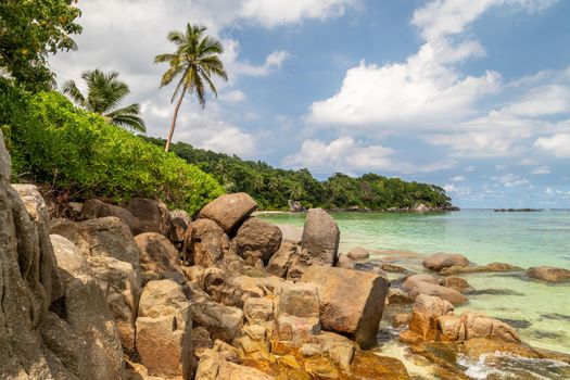 Paradise beach anse royale on Seychelles island Mahé with turguoise water, palms, white sand and granite rocks