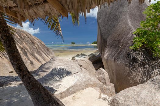 Beautiful beach Anse Source D'Argent on Seychelles island La Digue with white sand, blue water, granite rocks on the beach and blue sky with white clouds