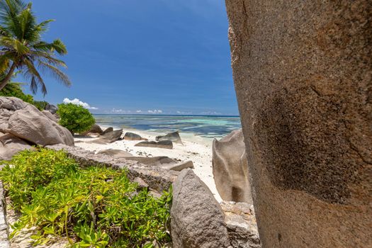 Beautiful beach Anse Source D'Argent on Seychelles island La Digue with white sand, blue water, granite rocks on the beach and blue sky with white clouds