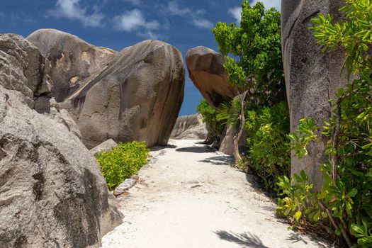 Beautiful beach Anse Source D'Argent on Seychelles island La Digue with white sand, blue water, granite rocks on the beach and blue sky with white clouds