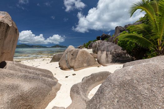 Beautiful beach Anse Source D'Argent on Seychelles island La Digue with white sand, blue water, granite rocks on the beach and blue sky with white clouds