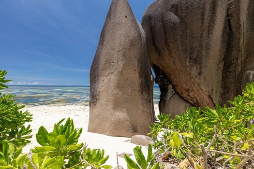 Beautiful beach Anse Source D'Argent on Seychelles island La Digue with white sand, blue water, granite rocks on the beach and blue sky with white clouds