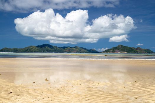 Beautiful beach Anse Source D'Argent on Seychelles island La Digue with white sand and blue sky with white clouds