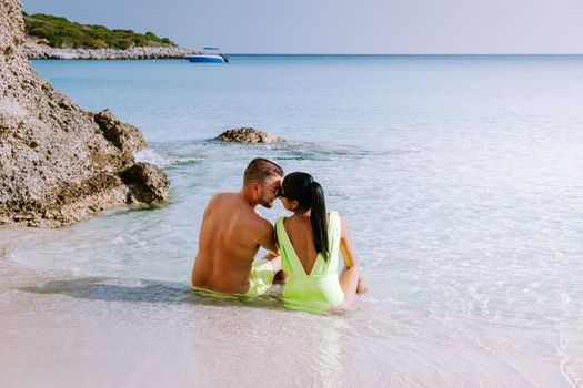 Tropical beach of Voulisma beach, Istron, Crete, Greece ,Most beautiful beaches of Crete island -Istron bay near Agios Nikolaos young couple mid age on vacation in Greece Crete