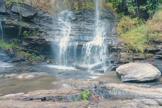 waterfall cascade creek water stream flowing in summer forest