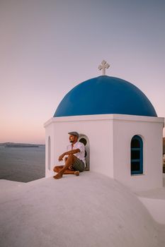 Santorini Greece, guy on vacation in Greece, young men on a luxury holiday at the island of Oia Greece Europe