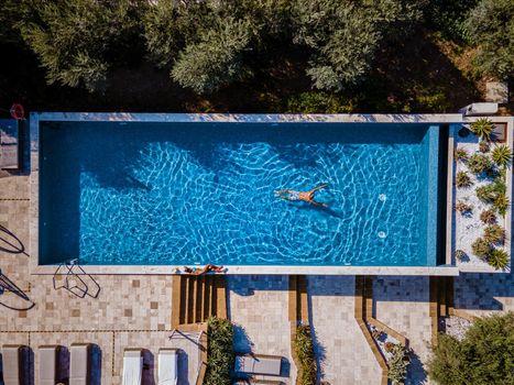 Luxury resort with a view over the wine field in Selinunte Sicily Italy. infinity pool with a view over wine fields in Sicilia, a couple on luxury vacation at the Island of Sicily Italy