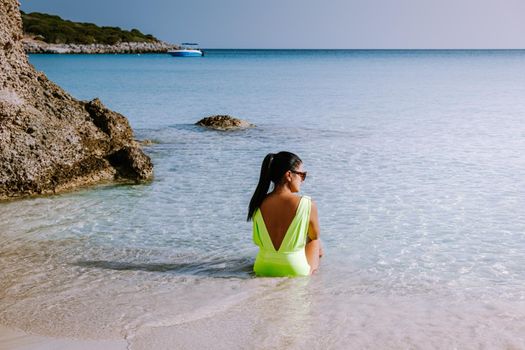 Tropical beach of Voulisma beach, Istron, Crete, Greece ,Most beautiful beaches of Crete island -Istron bay near Agios Nikolaos. young woman on the beach of Crete