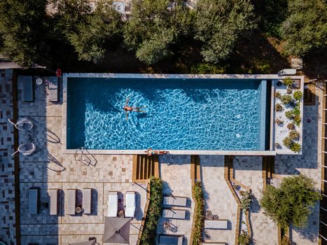 Luxury resort with a view over the wine field in Selinunte Sicily Italy. infinity pool with a view over wine fields in Sicilia, a couple on luxury vacation at the Island of Sicily Italy