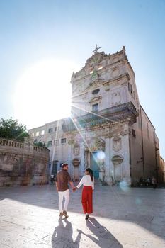 couple men and woman on citytrip, Ortigia in Syracuse Sicily Italy in the Morning. Travel Photography from Syracuse, Italy on the island of Sicily. 